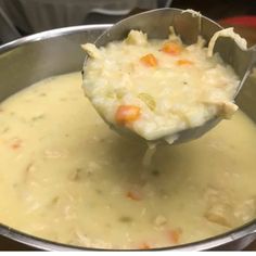 a ladle full of soup being stirred with a spoon