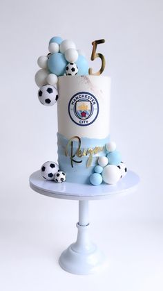 a cake with soccer balls on it and the number five in the middle is decorated