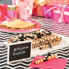 a table topped with lots of cookies on top of a black and white table cloth