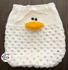 a white crocheted bag with a yellow duck on it