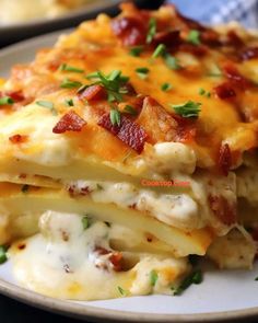 a white plate topped with lasagna covered in cheese and bacon