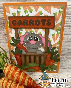 a card with carrots next to it on a table