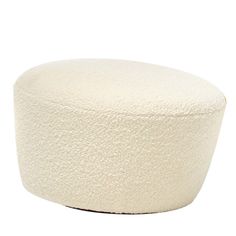 a white round ottoman sitting on top of a floor