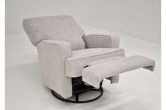 a recliner chair with a footstool sitting on it's back legs