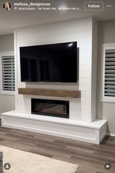 a flat screen tv mounted on the side of a wall above a fireplace in a living room