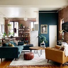 a living room filled with lots of furniture and decor on top of a hard wood floor