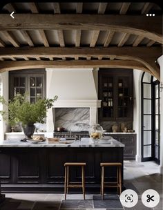 an open kitchen with black cabinets and marble counter tops is featured in this instagram