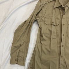 Vintage 1950s-1980s Military Size: small Measurements: armpit to armpit: 21” top to bottom: 31” Khaki Fitted Button-up Top, Retro Fitted Cotton Tops, Fitted Retro Cotton Tops, Fitted Long Sleeve Tops With Pockets, Retro Long Sleeve Top With Pockets, Classic Long Sleeve Khaki Tops, Fitted Khaki Cotton Tops, Casual Long Sleeve Tops For Vintage Fashion, Casual Long Sleeve Vintage Fashion Tops