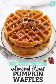 a close up of a waffle on a plate with pecans in the background