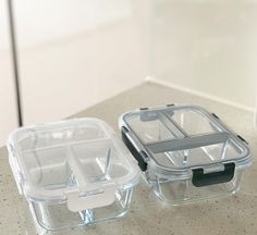 two plastic containers sitting on top of a counter