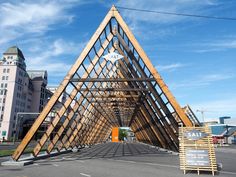 a large wooden structure sitting on the side of a road