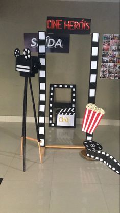 some movie themed items are on display in a room with gray walls and white tile flooring