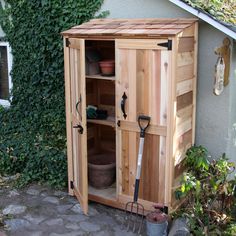 a garden shed with its door open and gardening tools in the storage area next to it