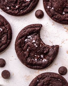 several chocolate cookies with sea salt on top and one cookie in the middle next to it