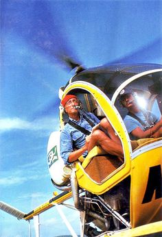 a man sitting in the cockpit of a helicopter