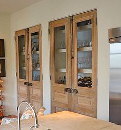 a kitchen with wooden cabinets and stainless steel refrigerator freezer next to it's glass doors