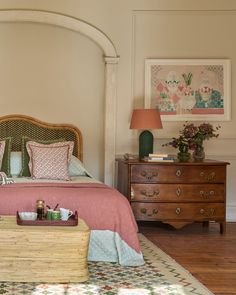 a bed sitting in a bedroom next to a dresser with drawers on top of it