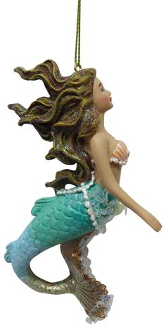 a christmas ornament with a mermaid on it's back and long hair