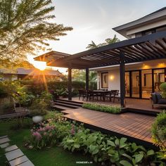 an outdoor patio with wooden decking surrounded by greenery and flowers at sunset or dawn