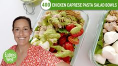 a woman standing in front of two trays of pasta salad bowls with chicken, tomatoes and spinach