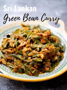 green bean curry on a yellow and white plate