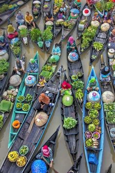 several boats filled with lots of different types of food