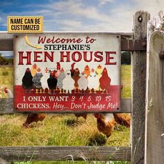 a sign that says hen house on the side of a wooden fence with chickens behind it