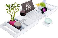 a white tray with a glass of wine and a potted plant on top of it