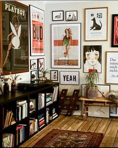 a living room filled with lots of pictures and books on the wall next to a wooden floor