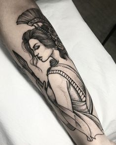 a woman with a fan tattoo on her arm