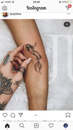 a woman's leg with tattoos on it and a fish tattoo on the arm