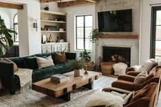 a living room filled with furniture and a flat screen tv mounted on the wall above a fireplace