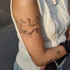 a woman with a tattoo on her arm