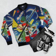 a pair of sneakers and a colorful jacket on a white surface