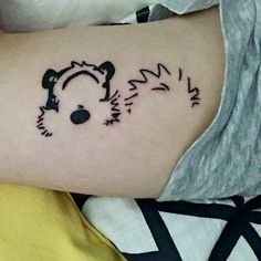 a small tattoo on the arm of a person with a bear head and ears in black ink