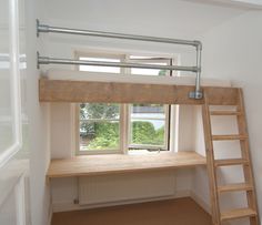 there is a loft bed with a ladder to the top and below it, in front of a window