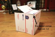 an open box sitting on top of a hard wood floor