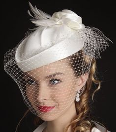 a woman wearing a white hat and veil