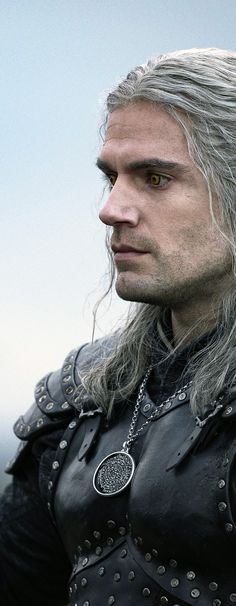 a man with grey hair and wearing a black leather outfit