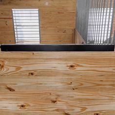 the inside of a building with wood paneling and metal bars on each side of it