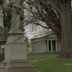 a statue in the middle of a cemetery