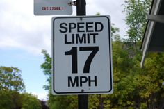 a speed limit sign is posted on a pole