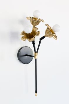 Black and Brass three light wall floral flower wall sconce with cast brass floral details.  Modern and romantic wall sconce. Bedroom Sconces