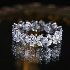 a diamond ring sitting on top of a table