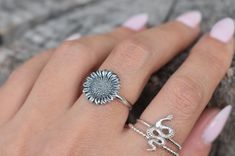 Sunflower Ring details:-Solid .925 sterling silver-Sunflower measures approx. 13x13mm-Smooth ring band measures 1.4mm wide-Comfortable and easily stackable!Connect with us on Instagram @a_wild_violet for sales and giveaways!**All items are in stock and ship within 2-5 business days from received payment (excluding Saturday/Sunday) from the US. If you are within the US please expect 3-7 business days for shipping transit and delivery. International orders please expect a minimum of 2 weeks for de Adjustable Sunflower Design Flower Ring, Adjustable Flower Ring For Everyday Wear, Adjustable Stackable Flower Ring, Adjustable Silver Ring With Sunflower Design, Adjustable Silver Stackable Flower Ring, Silver Sunflower Design Ring, Adjustable Stackable Flower Ring In Sterling Silver, Adjustable Stackable Sterling Silver Flower Ring, Sunflower Ring