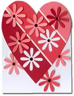 a heart shaped card with pink and white flowers on the side, cut out from paper