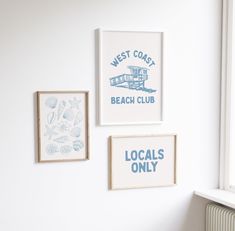 three framed pictures hang on the wall above a radiator