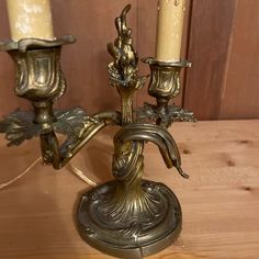 an antique brass candelabra with two candles