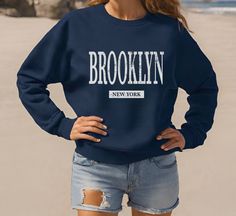 Brooklyn Sweatshirt, Womens Unisex New York Crewneck Shirt Gift Design has been distressed for a faded look. The sweatshirts in the pictures are solid color medium-heavy fabric with soft fleece inner lining. They are not pigment-dyed or vintage. .: 50% Cotton 50% Polyester .: Medium-heavy fabric (9.9 oz/yd²) .: Loose fit .: Sewn in label .: Runs true to size PROPER SIZING Please see photos to see a specific sizing chart for this shirt style. These shirts are unisex size, meaning they are not wom Blue Distressed Crew Neck Sweatshirt, Pink New York Sweatshirt, Brooklyn Sweatshirt, Brooklyn T Shirt Design, Brooklyn New York, Crew Neck Shirt, Sew-in Labels, Sweatshirts Women, Brooklyn