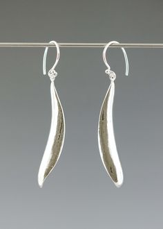 The hammered silver leaf shape captures the feel of nature in a modern form that elegantly follows the curve of your neck. Flattering your profile, this earring will be your new favorite to wear with everything.Dimensions: 2" long x 1/4"Lightweight french ear wireChoose from 3 metal options: polished sterling silver, oxidized (darkened) sterling silver, 14kt gold vermeilYour jewelry will arrive in a gift box tied with a ribbon. #earrings #earringsaesthetic #earringscollection #earrings German Jewelry, Small Drop Earrings, Earrings Aesthetic, Your Profile, Jewelry Stand, Hammered Silver, Silver Drop Earrings, Drop Necklace, Earrings Collection